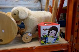 A selection of vintage children's toys including vintage accordion and a push-along dog