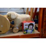 A selection of vintage children's toys including vintage accordion and a push-along dog