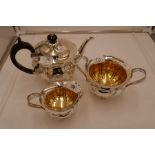 An exceptional silver and gilt Edwardian tea service of very high quality and design. On raised pede