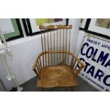 An antique stick back armchair having moulded seat