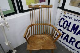 An antique stick back armchair having moulded seat