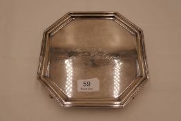 A heavy octagonal silver tray on four claw feet. With central engraving 'Presented to Major D R Morg