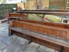 Two old Church pews, having panelled back with raised book shelf, 316cm