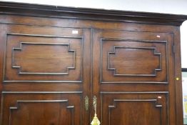 An antique bacon cupboard having panelled doors with 2 drawers to base, 155cm