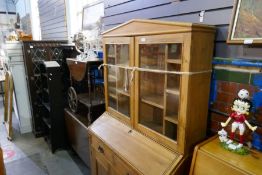 An old pine bureau bookcase having two drawers with cupboard below