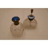 A sterling silver and enamel topped pretty cut glass scent atomiser. A decorative shape with ornate