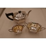 An octagonal Viner's Ltd silver tea service comprising a teapot with ebony handle and knop, 15cm x 2