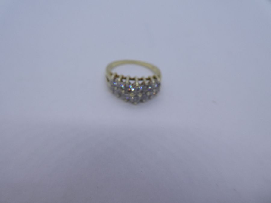 14K yellow gold ring with two raised rows graduating diamonds, marked 14K Size N/O; 4.4g approx