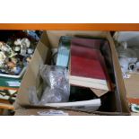 A box of various collectables including stamps, ephemera, cigarette cards, etc