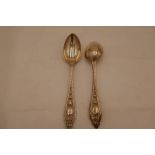 A pair of Victorian silver decorated dessert spoons with ornate handles and repoussed design with de