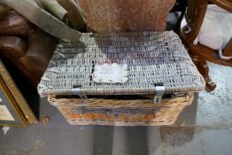 An old wicker trunk, with contents