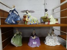 A Royal Doulton "At Ease" reclining lady, five other Royal Doulton ladies and a Elkington Tazza
