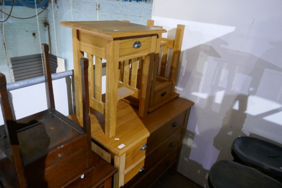 A modern pine chest having three drawers and a matching pair of bed side tables