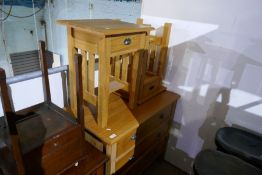 A modern pine chest having three drawers and a matching pair of bed side tables