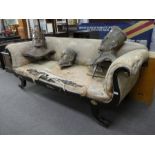 A 19th century 'Empire' style sofa with scroll arms on splay legs 215cms