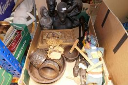 A box of mixed carved tribal art and puppets, etc