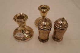 A pair of small candlesticks silver reeded rims, on raised pedestal circular foot. 8cm high approx.