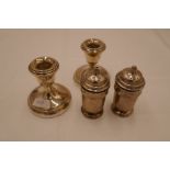 A pair of small candlesticks silver reeded rims, on raised pedestal circular foot. 8cm high approx.