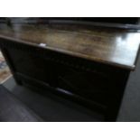 An antique oak coffer having carved paralleled front with thumbnail frieze, 116cms