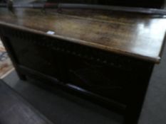 An antique oak coffer having carved paralleled front with thumbnail frieze, 116cms
