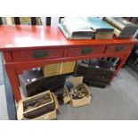 A Chinese red lacquer altar style side table having three drawers, 135cms