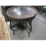 A Chinese carved Larchwood circular table with lower tier on folding base, 62cms