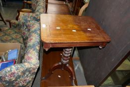 An antique mahogany tripod table having inlaid oblong top