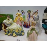 A quantity of Royal Doulton figurines including 'Easter Day', 'Paisley Shawl' and 'Autumn Breezes',