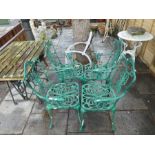 A set of 4 cast aluminium garden chairs and a slatted table