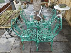 A set of 4 cast aluminium garden chairs and a slatted table