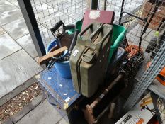 A trunk containing tools, a military Jerry can, a stick stand and sundry