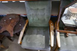 A pair of retro style armchairs having buttoned upholstery