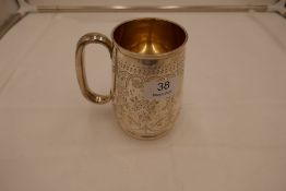 A large Victorian, heavy silver tankard with gilt interior. On a raised pedestal foot and engraved d