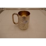 A large Victorian, heavy silver tankard with gilt interior. On a raised pedestal foot and engraved d