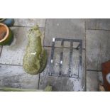 A reconstituted garden pig and an iron stand
