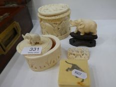 A carved ivory trinket box decorated elephants, a similar smaller example and other items
