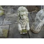 A garden figure of seated Lion holding shield