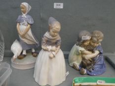 Three Royal Copenhagen figures to include two children hugging dog (3)