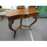 An antique mahogany console table having serpentine top on cabriole legs