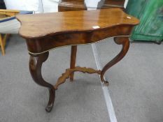 An antique mahogany console table having serpentine top on cabriole legs