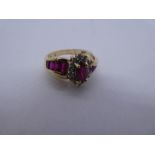 10K yellow gold ring with marquise cut ruby surrounded clear stones, the shoulders set with baguette