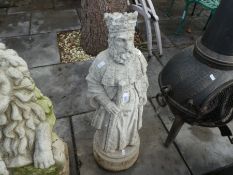 A garden statue of medieval King holding sword