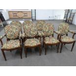 Seven Victorian style dining chairs, four having open arms with floral upholstery