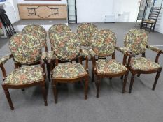 Seven Victorian style dining chairs, four having open arms with floral upholstery