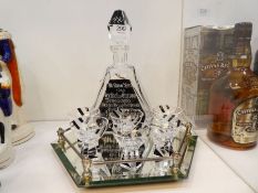 A glass Schnapps decanter with 6 glasses, having German WW2 decoration on a hexagonal mirrored tray