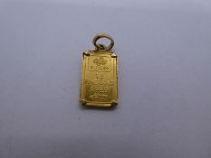 24ct yellow gold charm of a 1g gold bar, on yellow metal mount gross 1.5g approx