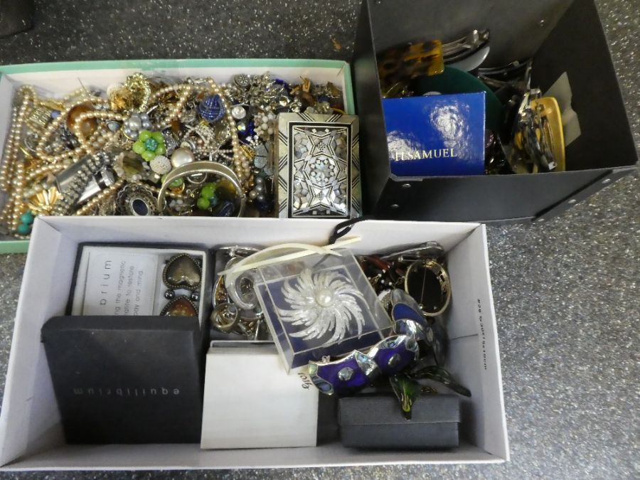 Shelf containing two boxes of mixed costume jewellery, watches, hair slides etc