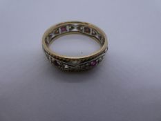 9ct white and yellow gold band ring inset rubies and clear stones, size S, 3.6g approx. Gold content