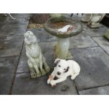 A shell shaped bird bath and two animal figures