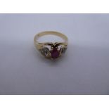 14ct yellow gold dress ring with central oval ruby flanked diamond chips, in heart shaped shoulders,